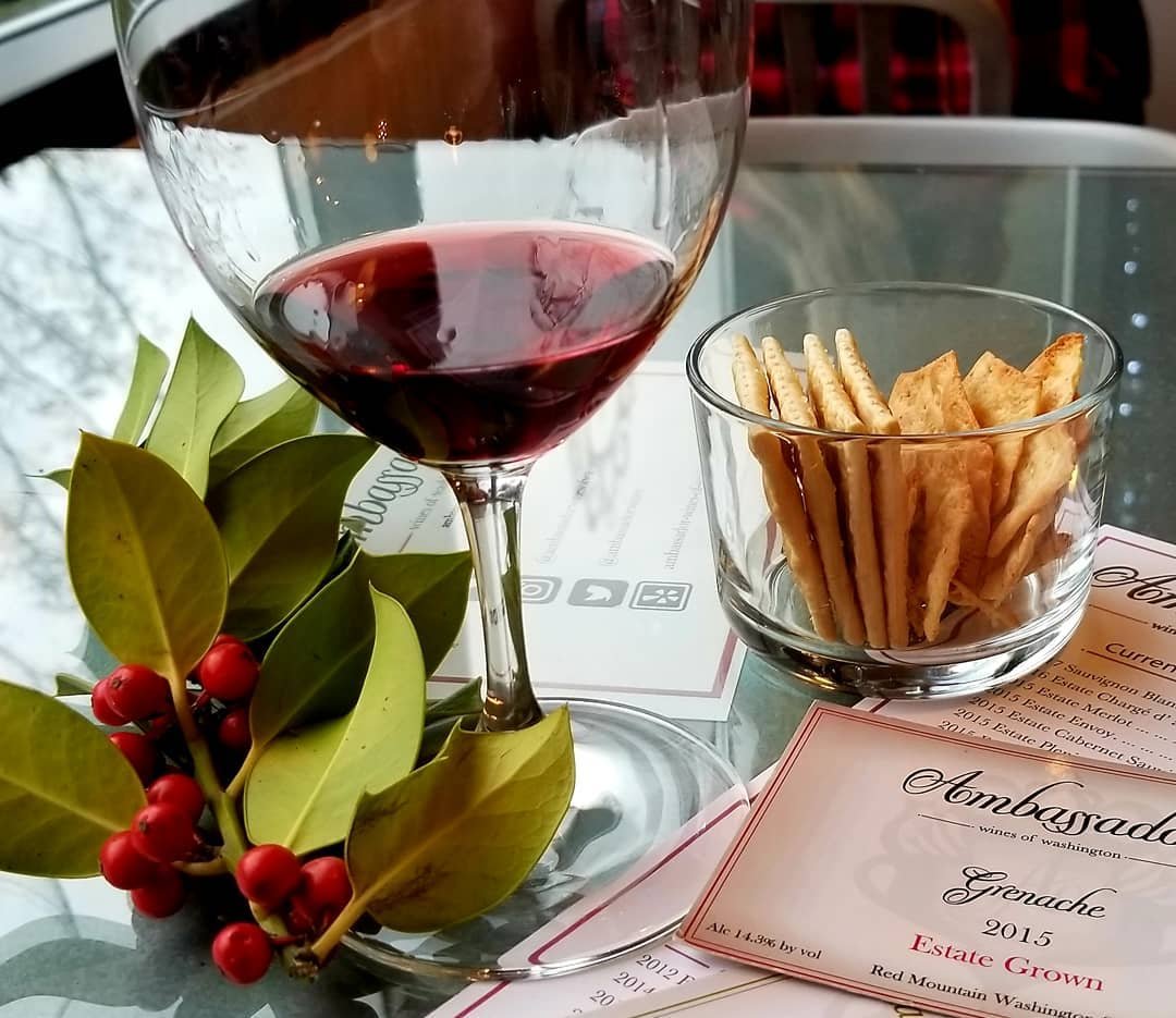 Glass of red wine and bowl of crakers at Ambassador Wines near Bothell, Washington.