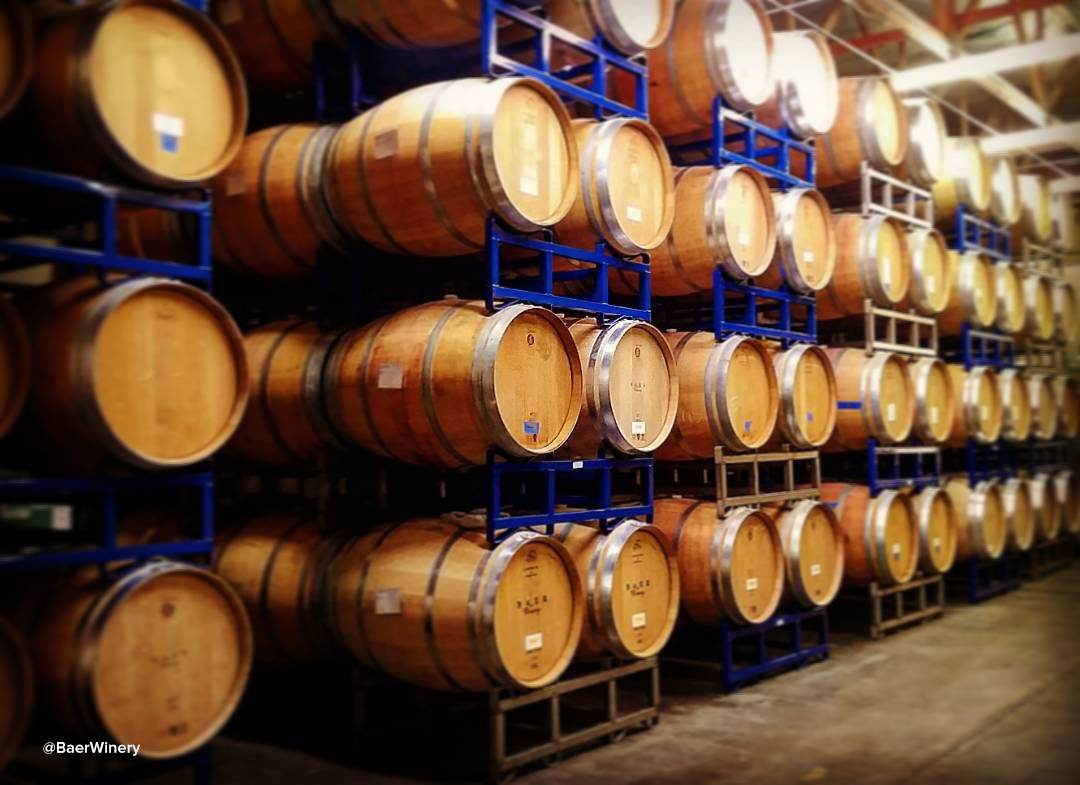 Wall full of wine barrels inside of Baer Winery near Bothell, Washington.