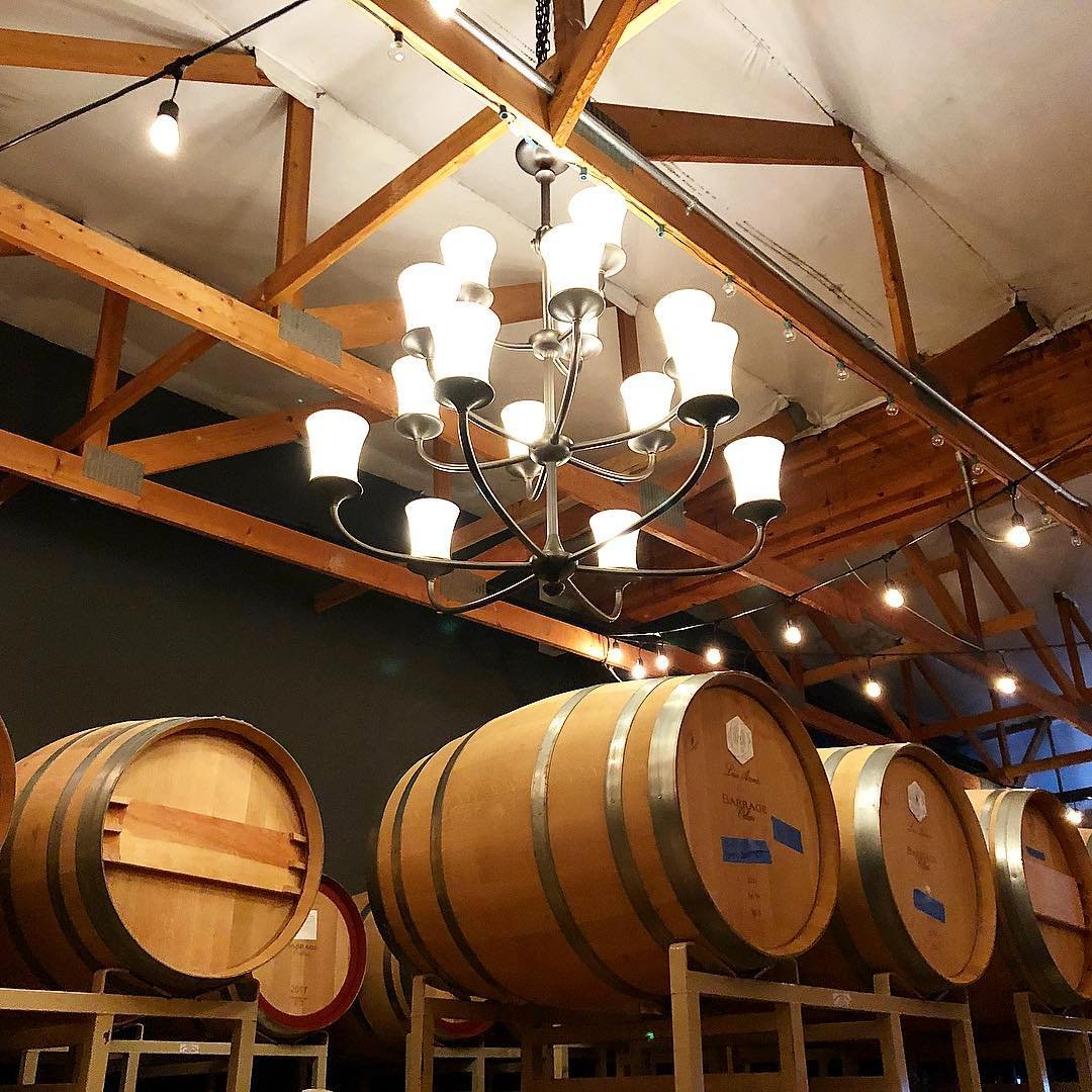 Wooden wine barrels inside of Barrage Cellars winery near Bothell, Washington.