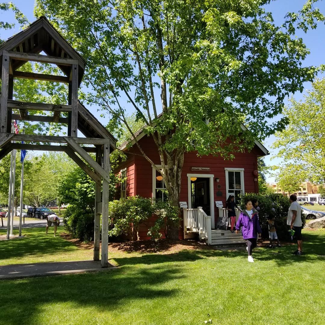 People walking out the front door of Bothell's First Schoolhouse museum.