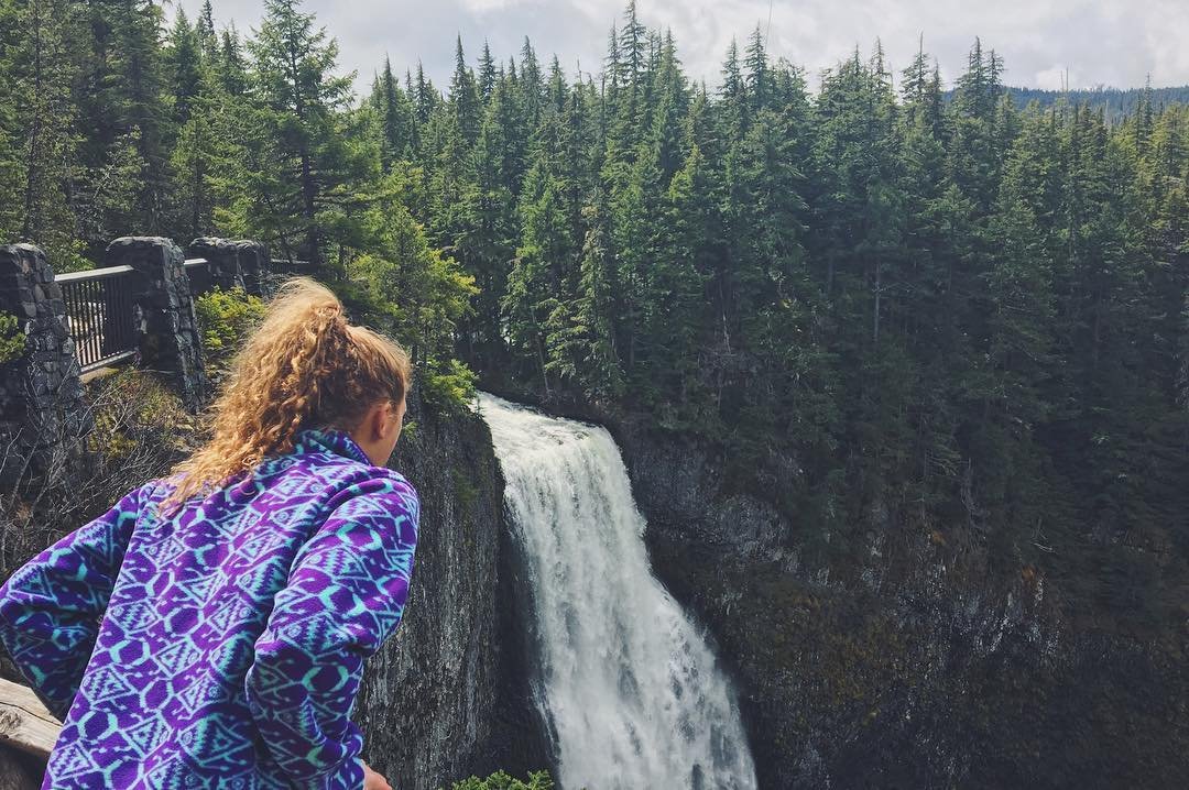 A woman looking over the waterfall at Cherry Creek Falls in Bothell, Washington.