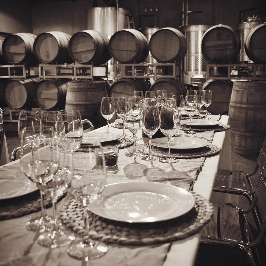 Table with place settings and wine glasses inside of Efeste Winery near Bothell, WA.