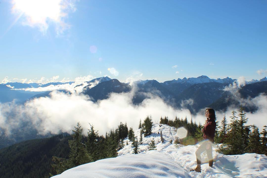 Woman at the top of the snowy Evergreen Mountain near Bothell, Washington.