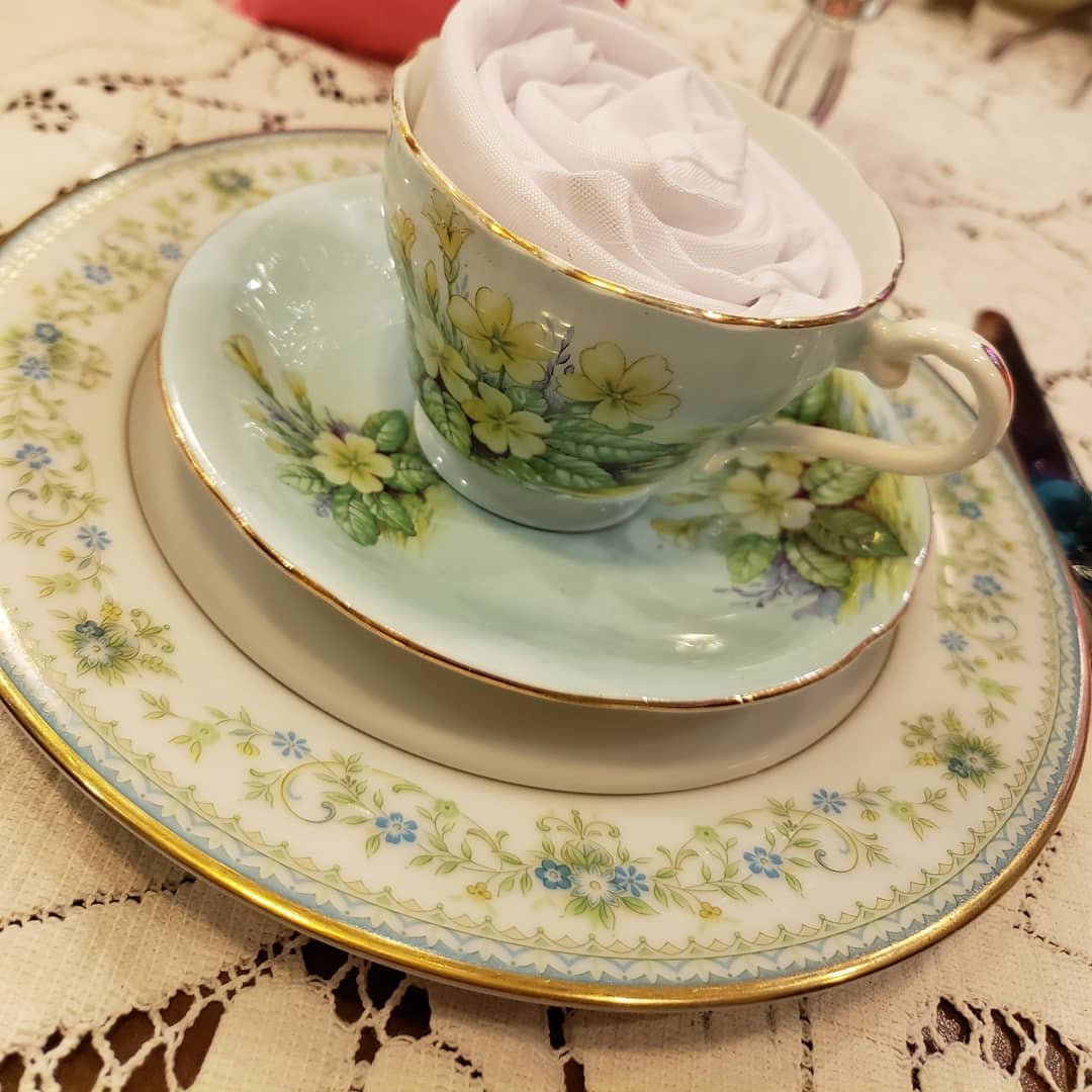 Floral tea cup with a napkin rose, at Graham's Royal Tea in Bothell, Washington.