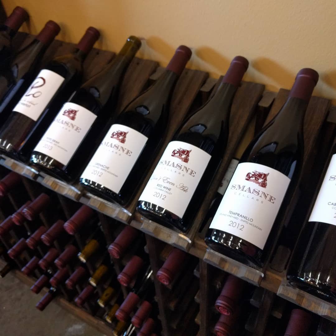 Wine bottles on a display rack at Smasne Cellars near Bothell, Washington.