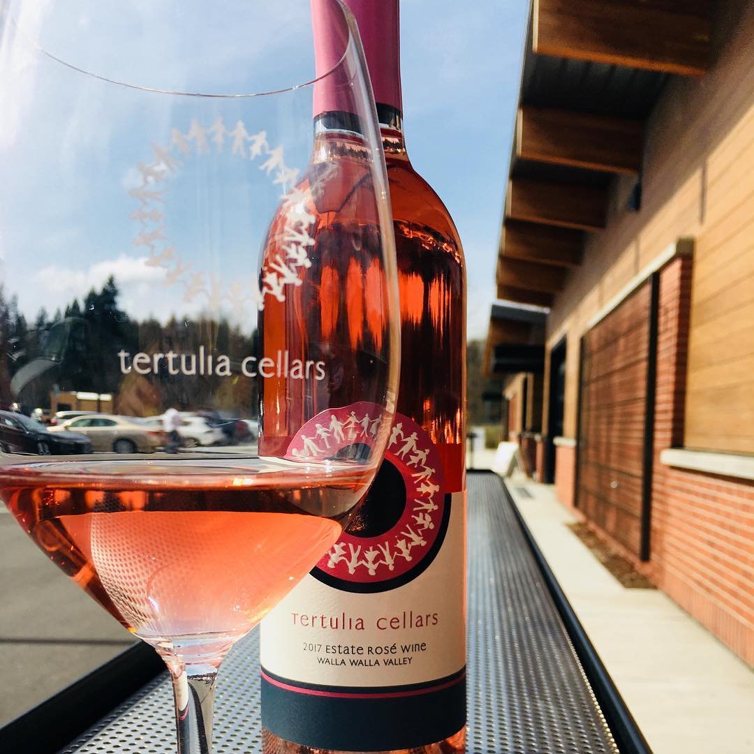 Bottle and glass of wine outside of Tertulia Cellars near Bothell, Washington.