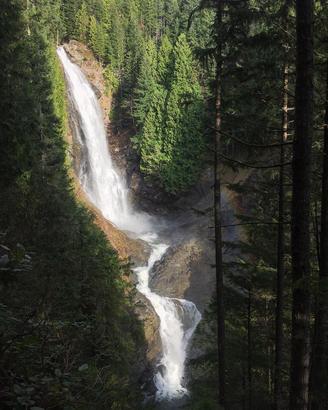 Large waterfall surrounded by trees at Wallace Falls near Bothell, Washington.